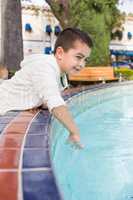 Mixed Race Young Hispanic Caucasian Boy by a Water Fountain