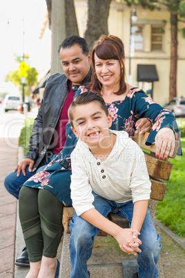 Mixed Race Young Family Portrait on a Park Bench