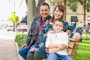 Mixed Race Young Family Portrait on a Park Bench