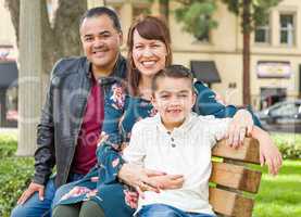 Mixed Race Young Family Portrait on a Park Bench