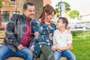 Mixed Race Young Family Portrait on a Park Bench