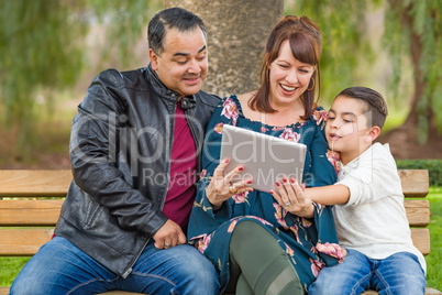 Caucasian Mother and Hispanic Father Using Computer Tablet