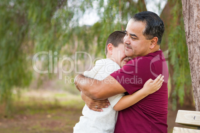 Mixed Race Hispanic and Caucasian Son and Father Hugging