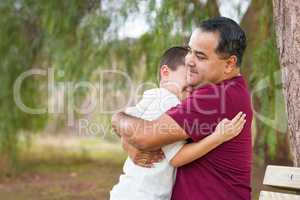 Mixed Race Hispanic and Caucasian Son and Father Hugging