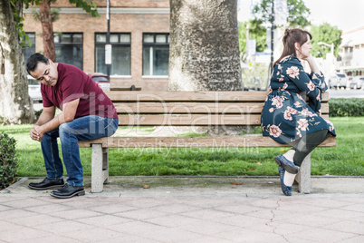 Unhappy Mixed Race Couple Sitting Facing Away From Each Other