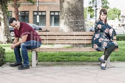 Unhappy Mixed Race Couple Sitting Facing Away From Each Other on