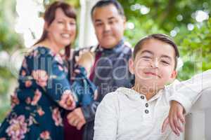 Mixed Race Couple Standing Behind Young Son