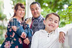 Mixed Race Couple Standing Behind Young Son