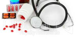 Stethoscope, pills and medical preparations isolated on white ba