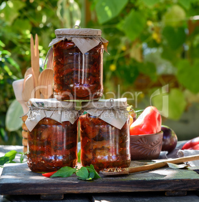 glass jars with canned aubergines in vegetable sauce