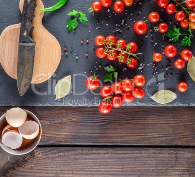 ripe red cherry tomatoes, cutting board