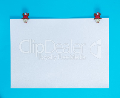 white square sheet of paper on a blue background