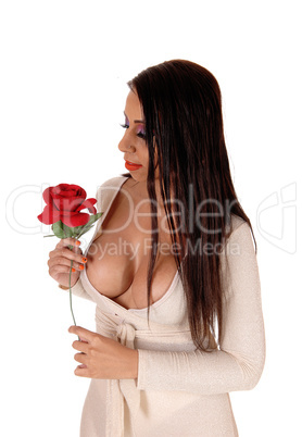 Woman standing in tracksuit holding a rose