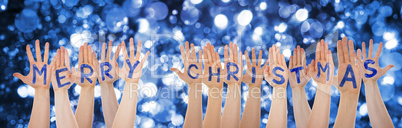 Hands Building Word Merry Christmas, Glittering And Sparkling Bokeh Background