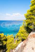 Sunny beautiful summer sea view with Greek blue sea and shallow
