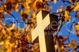 cross of a pilgrim way with autumnal painted leaves