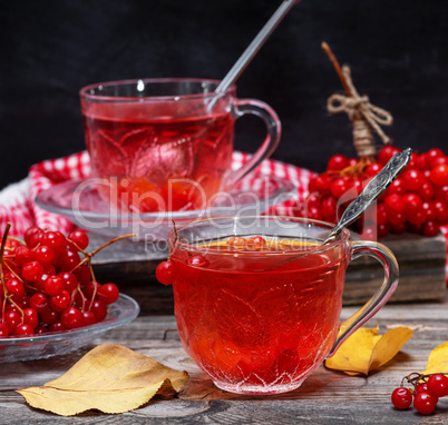 Fresh hot tea from viburnum berries in a transparent glass cup