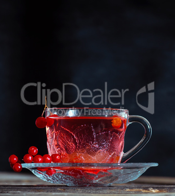 hot viburnum tea in a transparent cup with a handle