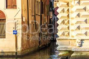 Venice rio, a typical narrow venetian canal between buildings