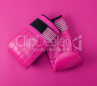 new pink sport leather boxing gloves on a pink background