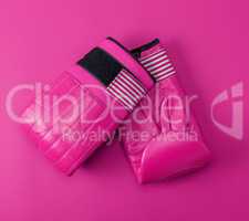 new pink sport leather boxing gloves on a pink background