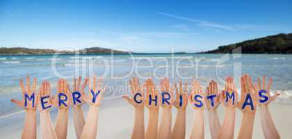 Many Hands Building Word Merry Christmas, Beach And Ocean