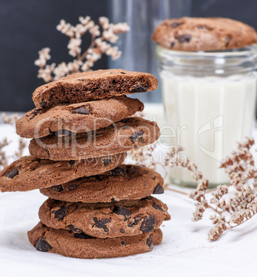 stack of round chocolate cookies on a white textile towel