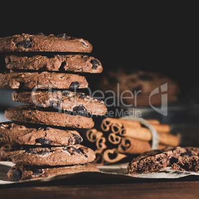 stack of round chocolate chip cookies on brown paper