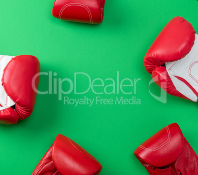 abstract green background with red leather boxing gloves