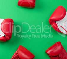 abstract green background with red leather boxing gloves