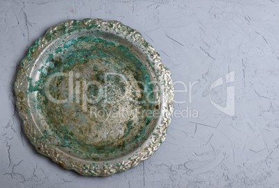 empty round metal plate on gray background, empty space