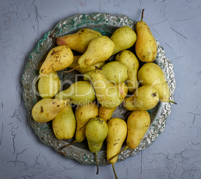 ripe yellow pears in a round iron plate