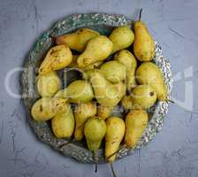 ripe yellow pears in a round iron plate