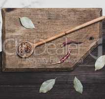 wooden spoon with  spices on a cutting board