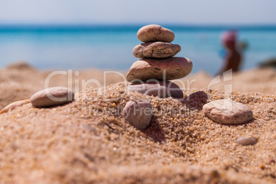 Close-up of a pyramid of stones laid on a sea beach