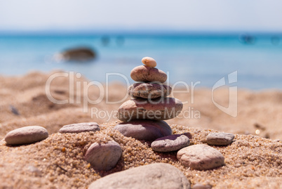 Close-up of a pyramid of stones laid on a sea beach