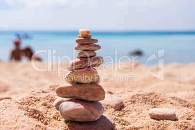 Close-up of a pyramid of stones laid on a sea beach