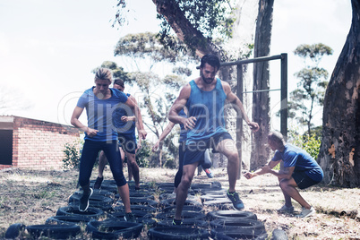 People receiving tire obstacle course training