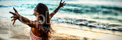 Side view of woman stretching out her arms