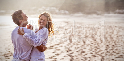 Mature couple having fun together at beach