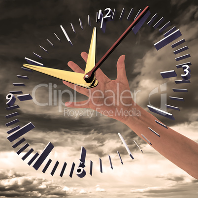 Hand reaches for clock