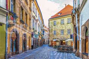 Prague Street in Old town and a street restaurant, no people