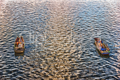 Fishermen in the boats in the river Vltava