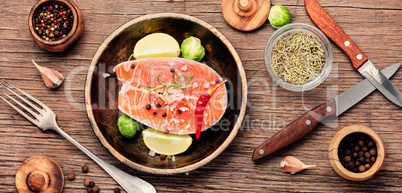 Salmon steaks on black wooden background