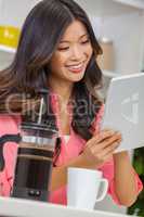Asian Chinese Woman Girl in Kitchen Using Tablet Computer