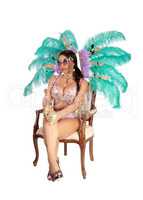 Beautiful woman in carnival costume sitting on chair