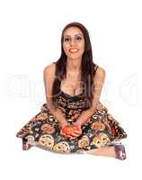 Lovely woman sitting on the floor holding a pumpkin