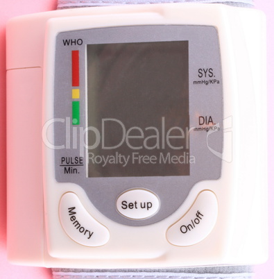 Automatic Wrist Digital blood pressure monitor on pink backgroun