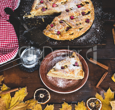 piece of traditional apple pie puff pastry on a brown ceramic pl