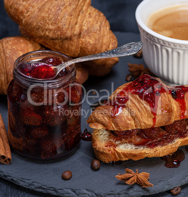 baked croissant with strawberry jam